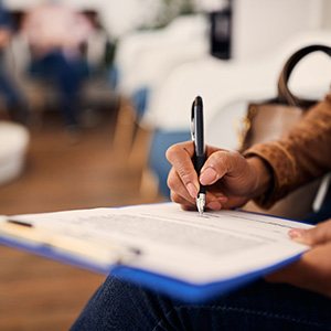 Patient filling out forms in lobby