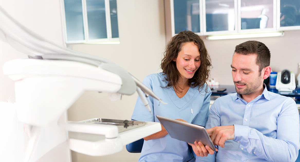 Beaverton dental team member showing a tablet to a patient