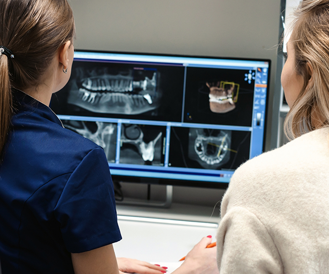 Dentist showing a patient digital x rays of their teeth and jaws