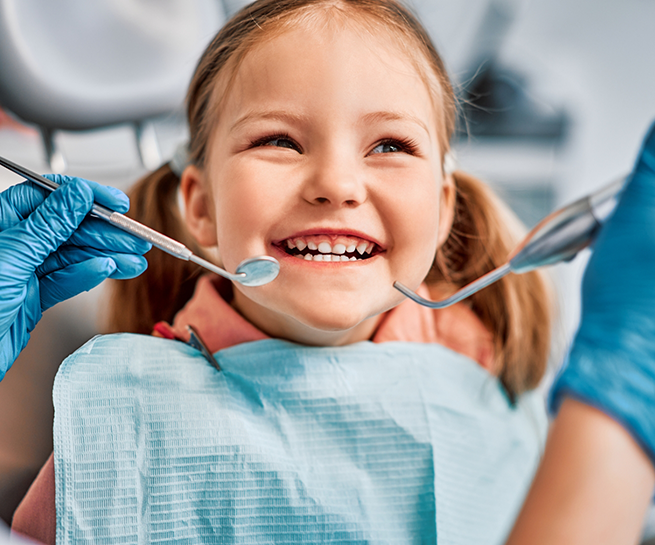 Young girl grinning during her dental checkup