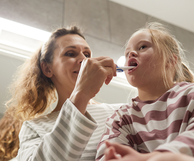 Dentist brushing a childs teeth
