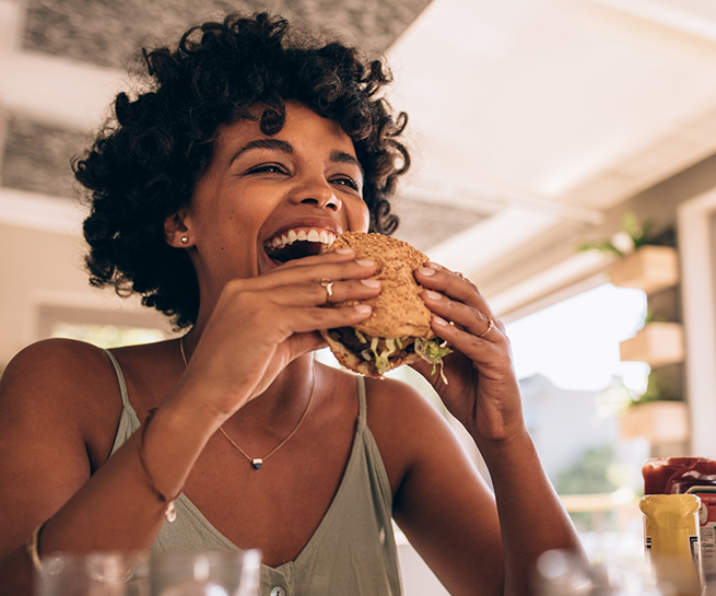 Woman biting into a burger