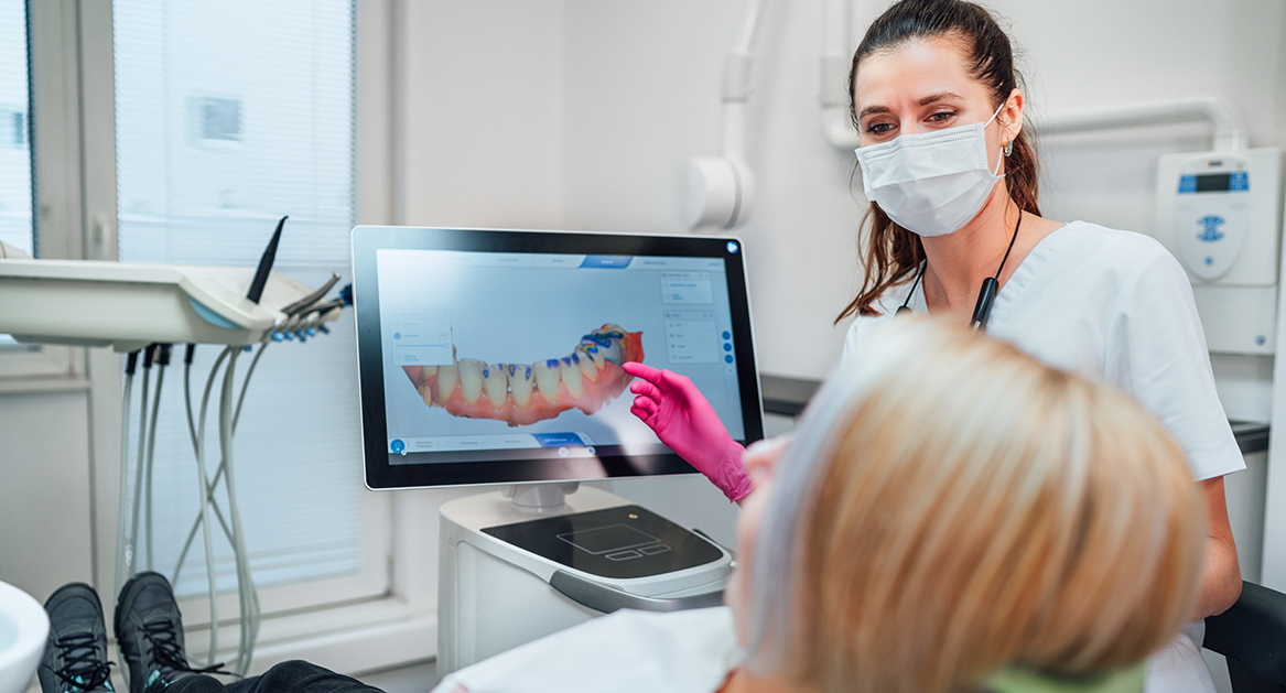 Dentist showing a patient a screen with digital impressions of their teeth
