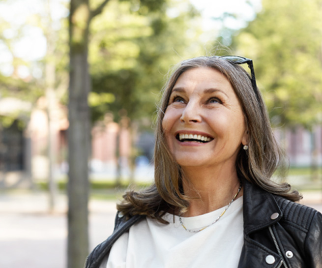 Senior woman standing outside and smiling
