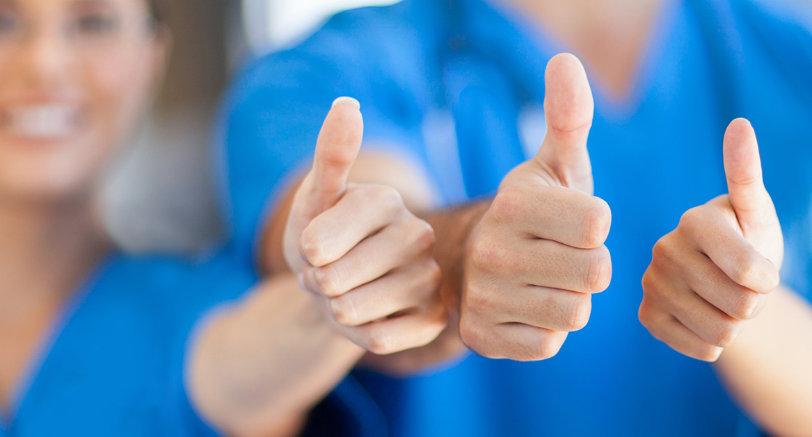 Three Beaverton dental team members giving thumbs up
