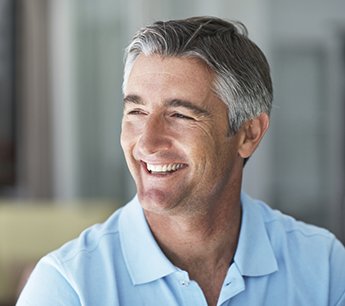 Smiling older man in a white collared shirt