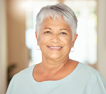 Smiling senior woman in a pale blue blouse