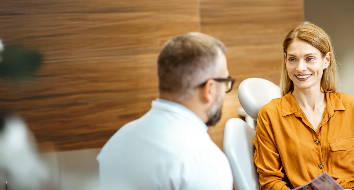 Woman talking to her dentist during a preventive dental checkup