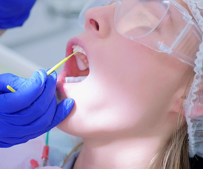 Dental patient having fluoride applied to their teeth