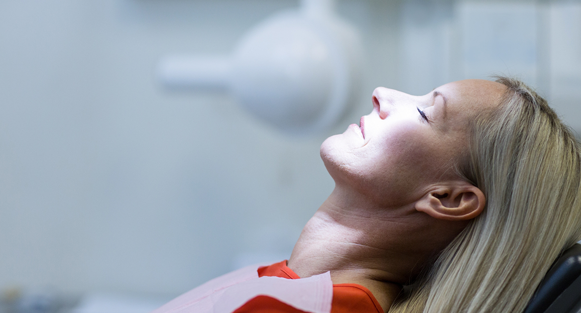 Woman in the dental chair relaxing with her eyes closed thanks to sedation dentistry in Beaverton